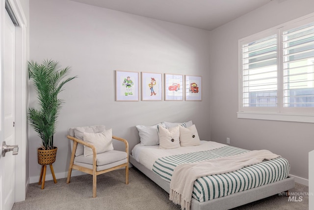 bedroom with baseboards, multiple windows, and carpet flooring