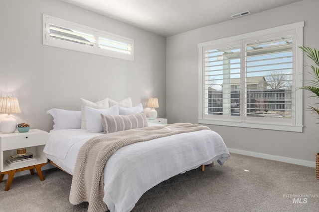 carpeted bedroom featuring visible vents and baseboards