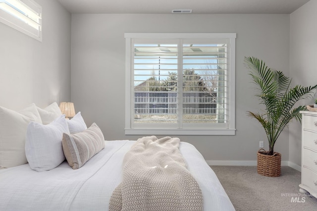 carpeted bedroom with visible vents and baseboards