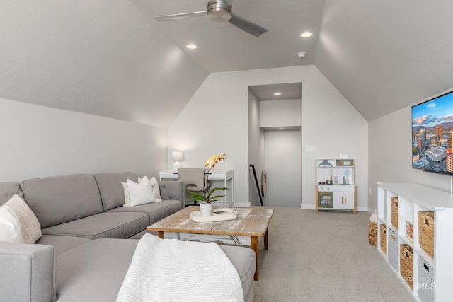 living room with baseboards, light carpet, a ceiling fan, and vaulted ceiling