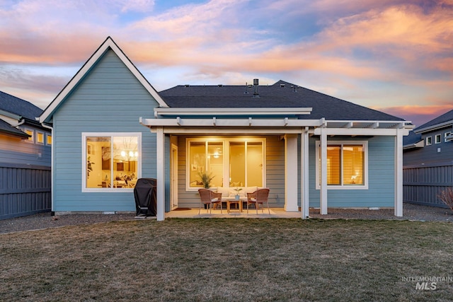 back of house with a patio, a lawn, a pergola, and fence