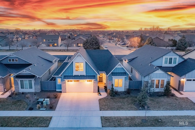 craftsman-style home with a residential view, board and batten siding, driveway, and fence