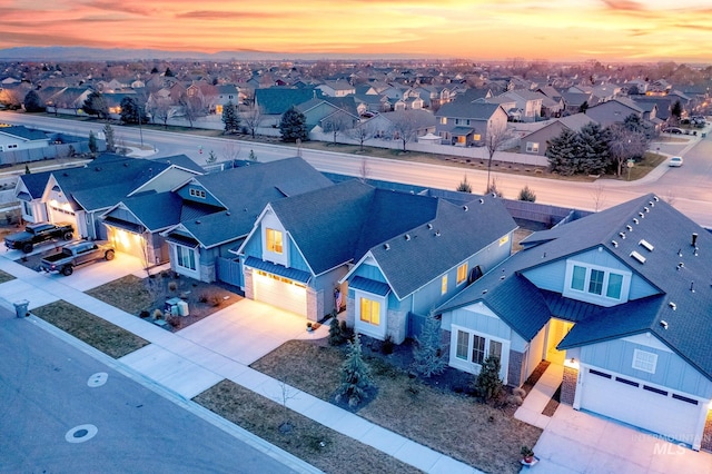 aerial view at dusk featuring a residential view