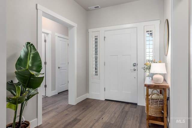 entryway featuring visible vents, baseboards, and wood finished floors