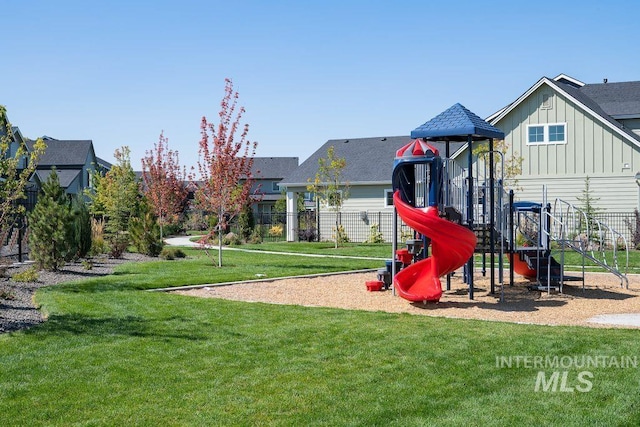 communal playground with a lawn and fence