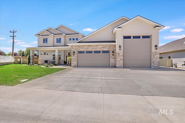 505 Stonehedge Loop, Twin Falls, ID 83301 - view of front facade with a garage, concrete driveway, stone siding, covered porch, and stucco siding