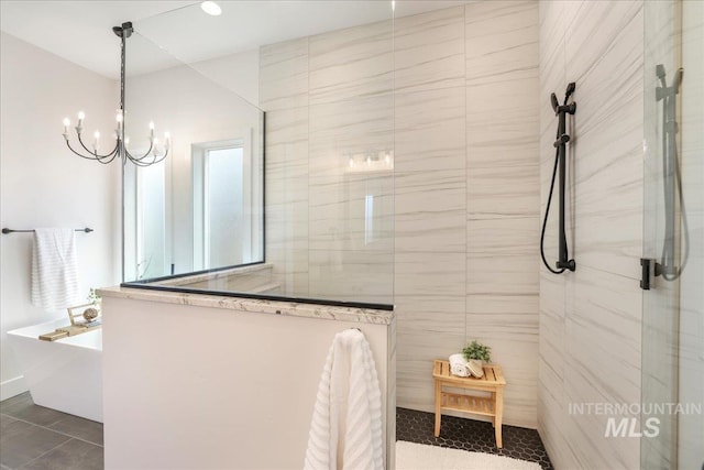 505 Stonehedge Loop, Twin Falls, ID 83301 - bathroom featuring walk in shower, a freestanding tub, a chandelier, and tile patterned flooring