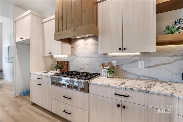 505 Stonehedge Loop, Twin Falls, ID 83301 - kitchen with stainless steel gas stovetop, light stone counters, light wood-style floors, and tasteful backsplash