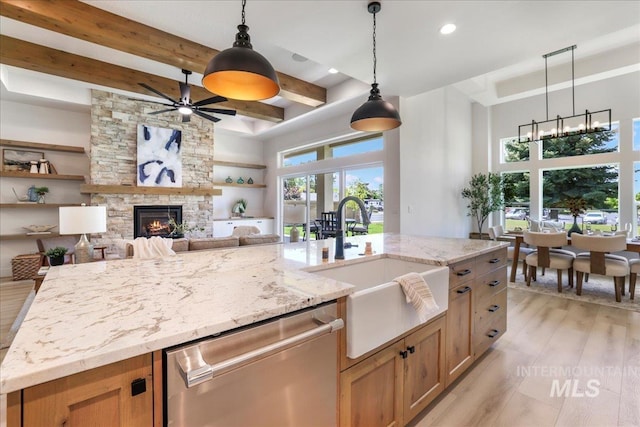 505 Stonehedge Loop, Twin Falls, ID 83301 - kitchen with dishwasher, beamed ceiling, ceiling fan, a stone fireplace, and light wood-type flooring