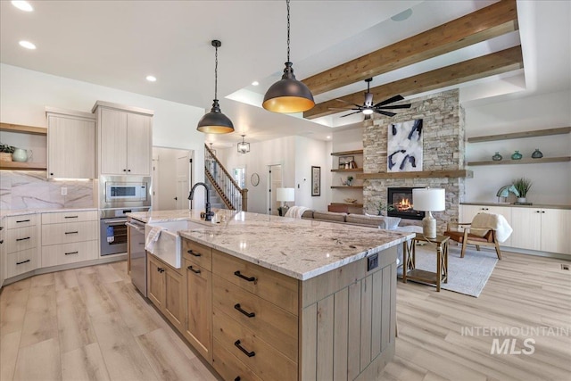 505 Stonehedge Loop, Twin Falls, ID 83301 - kitchen featuring open shelves, stainless steel appliances, light wood-type flooring, tasteful backsplash, and beam ceiling