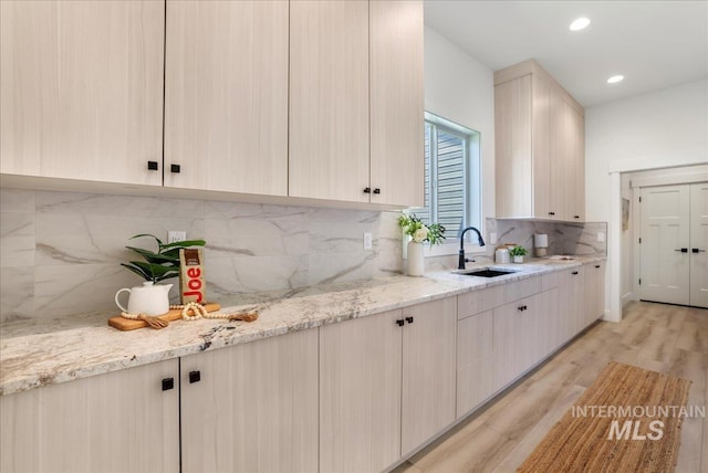 505 Stonehedge Loop, Twin Falls, ID 83301 - kitchen featuring light wood-style floors, decorative backsplash, light stone countertops, and recessed lighting