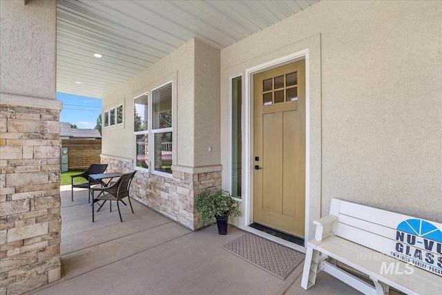 505 Stonehedge Loop, Twin Falls, ID 83301 - doorway to property featuring stucco siding, stone siding, and covered porch