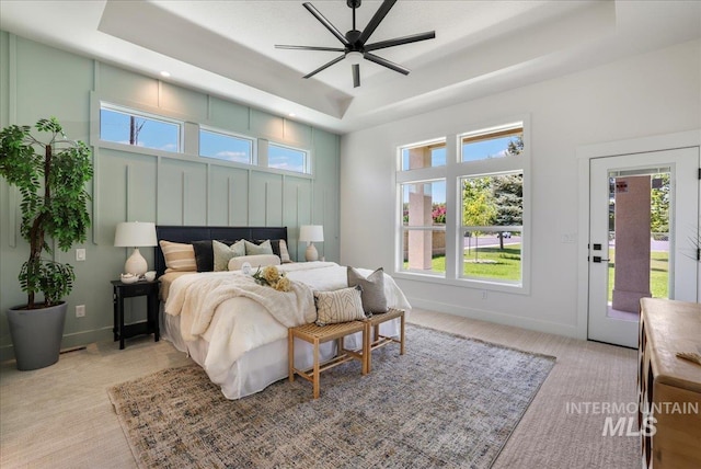 505 Stonehedge Loop, Twin Falls, ID 83301 - bedroom with a tray ceiling, light colored carpet, and multiple windows
