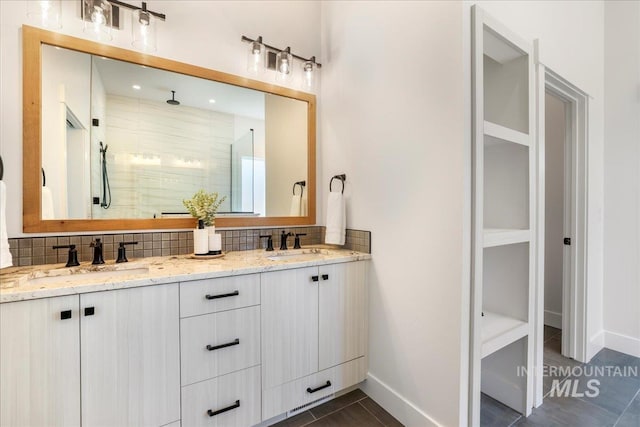 505 Stonehedge Loop, Twin Falls, ID 83301 - bathroom featuring tasteful backsplash, double vanity, a shower stall, and tile patterned floors