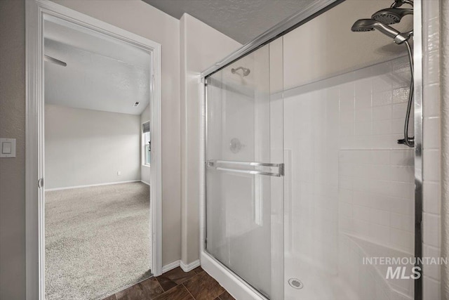 bathroom with a textured ceiling and walk in shower