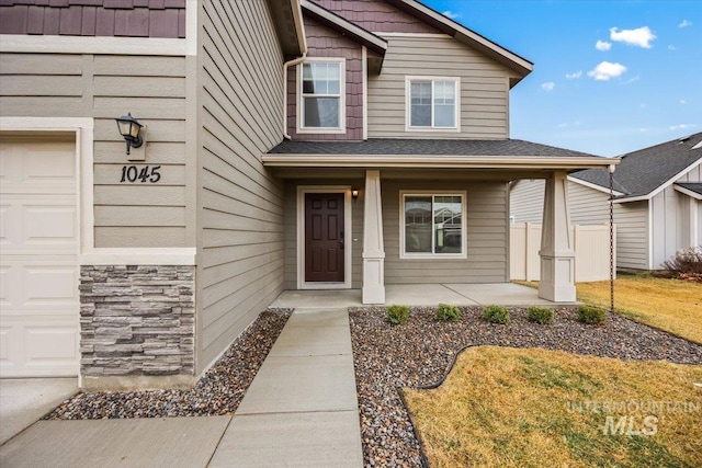 property entrance featuring a porch and a garage