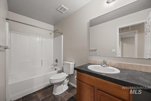 full bathroom featuring shower / tub combination, vanity, a textured ceiling, and toilet