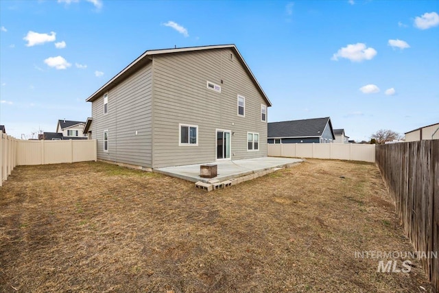 rear view of property with a lawn and a patio area