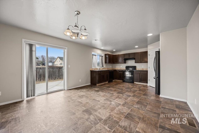 kitchen featuring sink, decorative light fixtures, a chandelier, dark brown cabinets, and black appliances