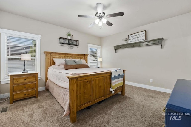carpeted bedroom with baseboards and a ceiling fan
