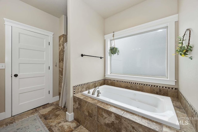 full bathroom featuring a tub with jets and curtained shower