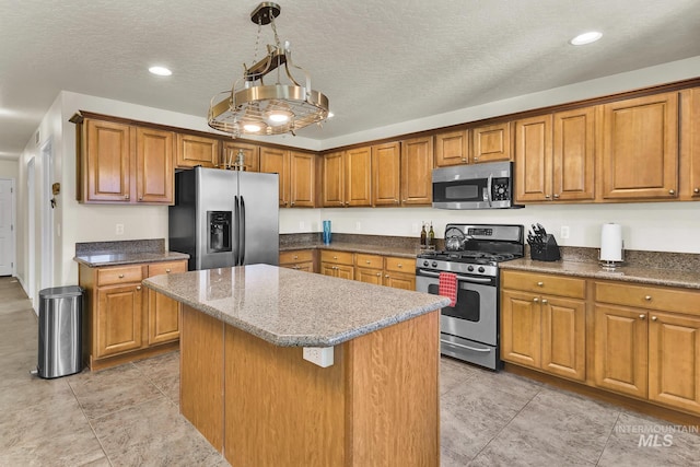 kitchen featuring stainless steel appliances, brown cabinets, recessed lighting, and a textured ceiling