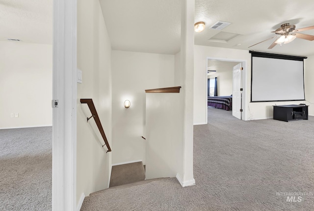 staircase with carpet flooring, ceiling fan, and baseboards