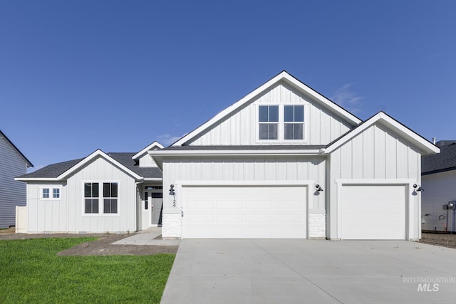 modern farmhouse with an attached garage, roof with shingles, board and batten siding, and driveway