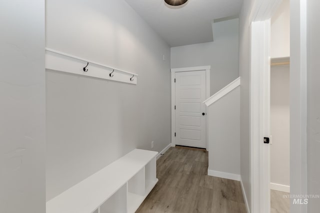 mudroom featuring light wood-style flooring and baseboards