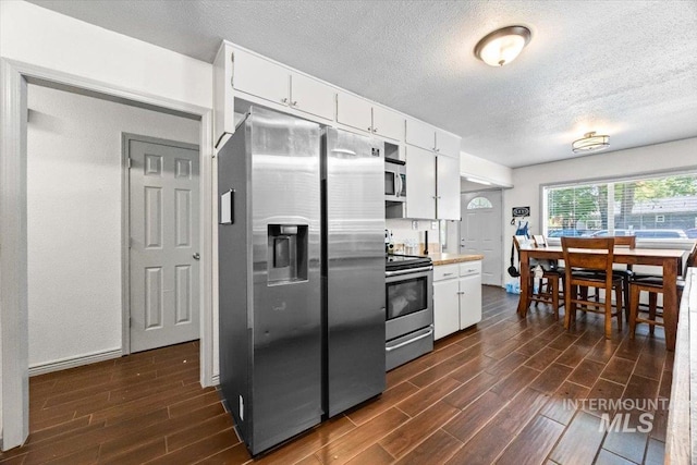77 S Canyon St, Nampa, ID 83651 - kitchen featuring stainless steel appliances, dark wood-style flooring, a textured ceiling, white cabinetry, and light countertops