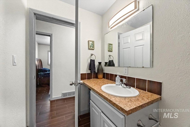 77 S Canyon St, Nampa, ID 83651 - bathroom featuring vanity, wood finish floors, and a textured wall