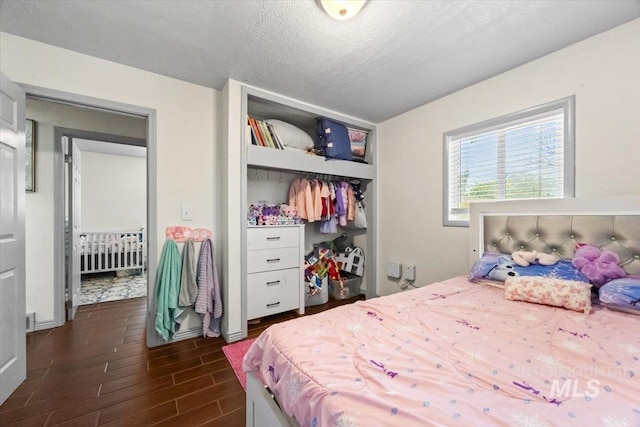 77 S Canyon St, Nampa, ID 83651 - bedroom with a closet, dark wood finished floors, a textured ceiling, and radiator heating unit