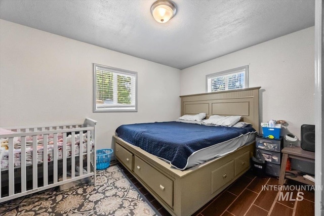 77 S Canyon St, Nampa, ID 83651 - bedroom featuring multiple windows and a textured ceiling