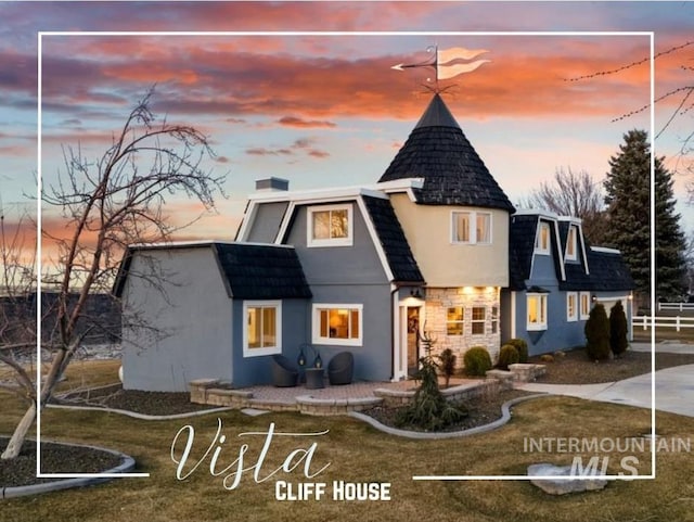 back of property featuring stucco siding and a chimney