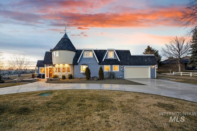 view of front of home with fence, mansard roof, an attached garage, a front lawn, and concrete driveway