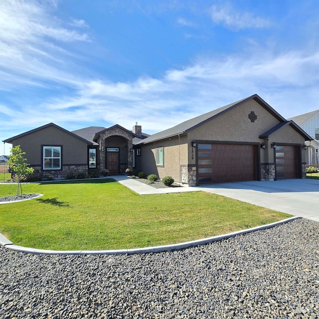 view of front of property featuring a garage and a front lawn