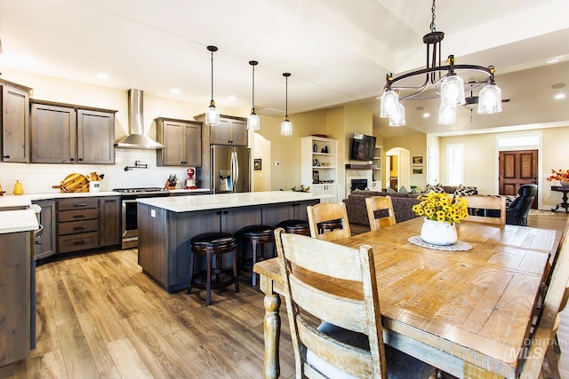 dining area with a notable chandelier and light hardwood / wood-style floors