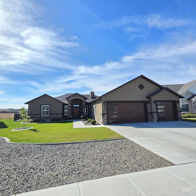 view of front of home with a front yard and a garage