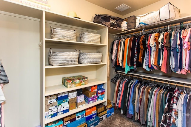 walk in closet with carpet