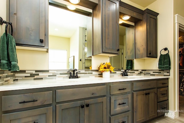 bathroom featuring tasteful backsplash, hardwood / wood-style flooring, and vanity