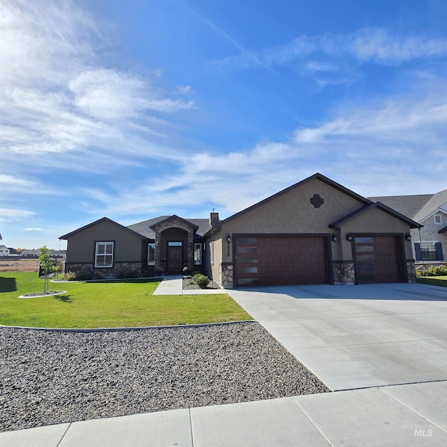 view of front of house featuring a garage and a front yard