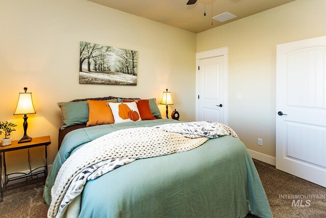 bedroom with dark colored carpet and ceiling fan