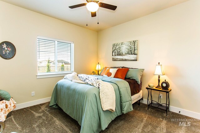 bedroom with ceiling fan and dark carpet