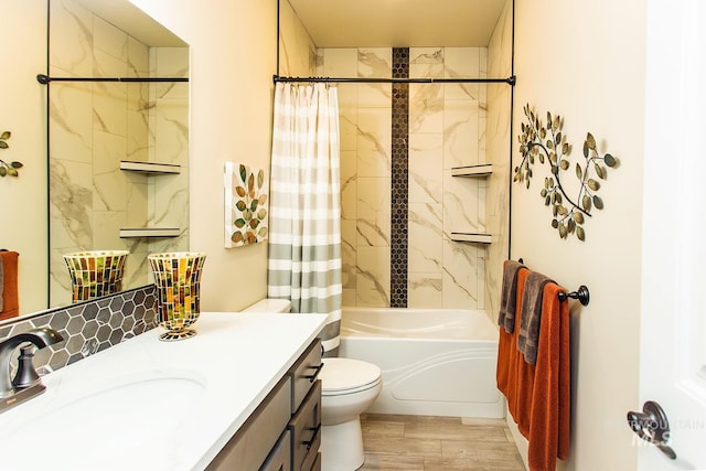 full bathroom with shower / tub combo with curtain, hardwood / wood-style floors, vanity, and toilet