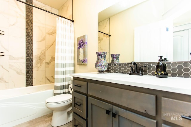 full bathroom with toilet, tasteful backsplash, wood-type flooring, shower / bath combo, and vanity