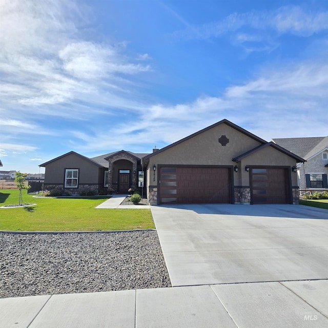 view of front of home with a front yard and a garage