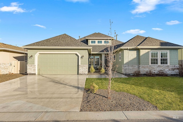 view of front of home with a garage and a front yard