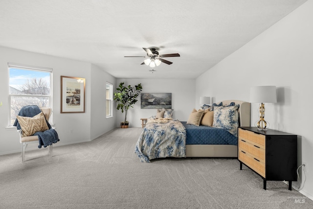 bedroom featuring light carpet, baseboards, and a ceiling fan