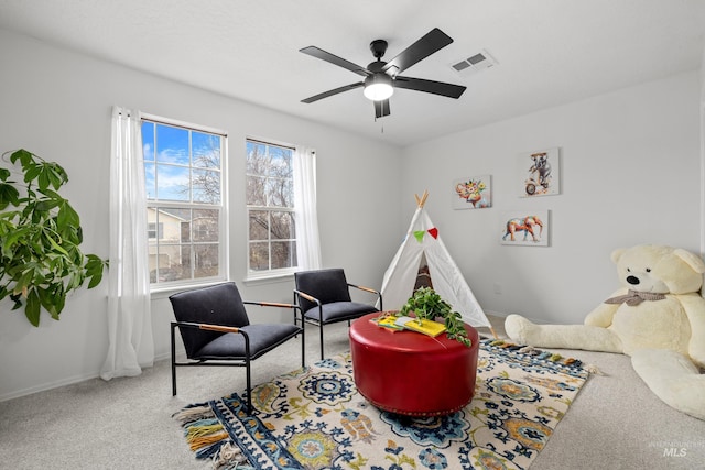 interior space with a ceiling fan, baseboards, visible vents, and carpet flooring