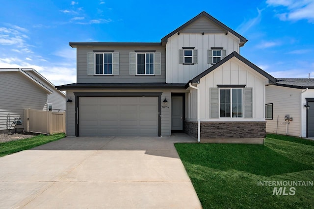 view of front facade with fence, concrete driveway, a garage, stone siding, and board and batten siding